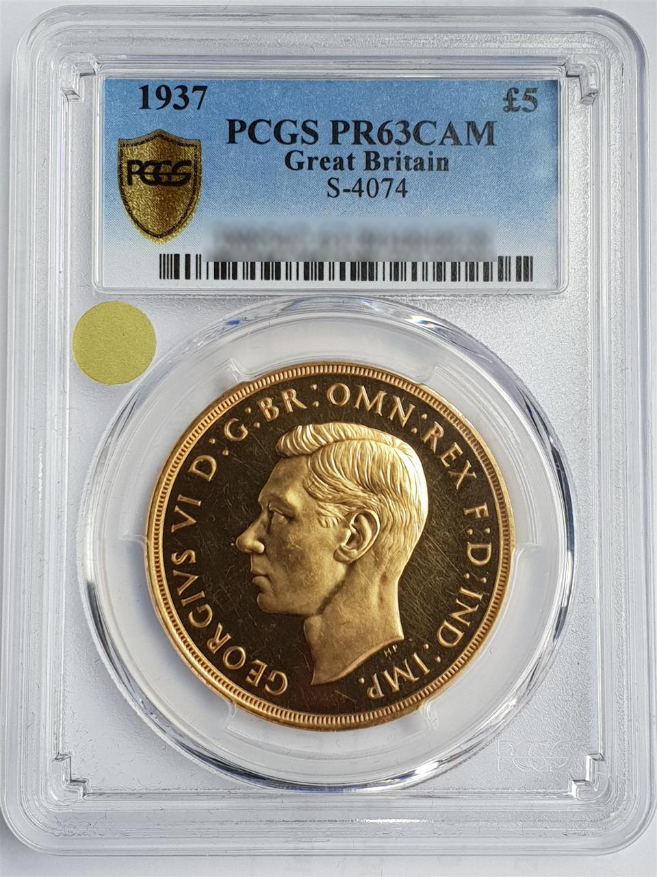 A 1937 George VI £5 gold coin, encapsulated by PCGS